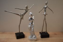 A pair of metal ballerina figurines mounted on black square bases, measuring 37cm tall
