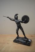 A patinated metal figure modelled as Leonidas preparing to throw a javelin, mounted on marble