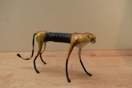 An unusual decorative resin Cheetah study, raised on slim legs, measuring 16cm tall.