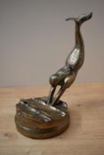 A heavy cast brass figurine depicting a mermaid diving into water, measures 23cm tall.