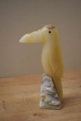 A hand-carved onyx stone toucan study on a raised marble style base, measures 19cm tall.