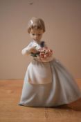 A Nao by Lladro porcelain figurine 'Girl with Posey of Flowers' measuring 19cm tall, complete with