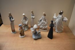 A group of Lladro porcelain and similar figures/figurines to include 'Girl with Lamb' model number
