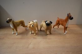 A group of four dog studies to include Beswick Pottery Pug 'Cutmil Cute' (Large) model number 1997