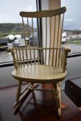 A traditional painted spindle back rocking chair