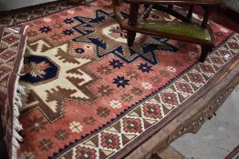 A decorative Anatolean/Caucasian rug with bold geometric medallions against an abrashed ground and