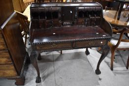 A 20th century reproduction desk, of Victorian design with gadrooned edge detail and an