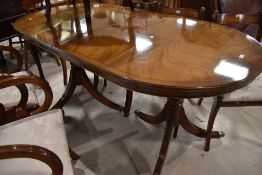 A reproduction mahogany Regency style twin pedestal dining table and six dining chairs, of rounded