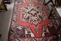 A Persian rug, approx. 200 x 130cm (badly faded)