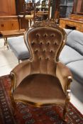 A reproduction stained frame button back easy chair in the Victorian style