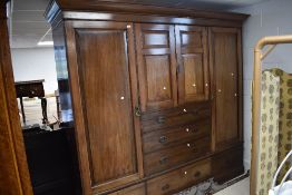 A late Victorian quadruple wardrobe having central press and drawer section over three drawer base ,