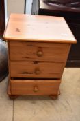 A modern pine bedside chest of three drawers, height approx. 59cm