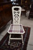 A painted kitchen chair having narrow back and shabby chic style decoration