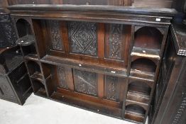 A period oak dresser back, having carved decoration to panels, some damage to shelves, width approx.