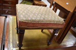 A Victorian rosewood stool, the padded rectangular seat raised on turned and octagonal tapering legs
