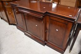 A nice quality reproduction breakfront sideboard having central pull out scroll design skiver top