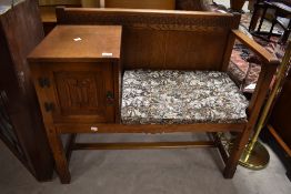 An Old Charm linen fold oak telephone table, of typical design, label to door, 80cm x 94cm x 46cm