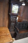 An 18th Century oak cased long case clock , having square hood with brass finials, containing