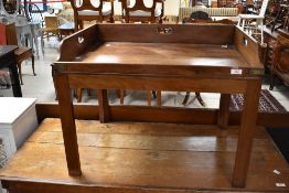 A reproduction mahogany butlers tray topped coffee table with brass bound corners 57cm x 74cm x