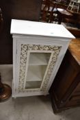 A modern white painted and glazed display cabinet with pierced scroll border 99cm x 52cm x 29.5cm