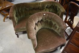 An early 20th Century low back settee and similar armchar, with green dralon button back upholstery