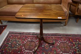 A 19th Century Regency style occasional table having rectangular top on turned column, with brass