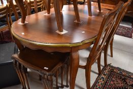 A modern table and set of six (four plus two) dining chairs