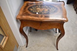 A French style ladies writing table having inlaid decoration and fitted interior, width approx.