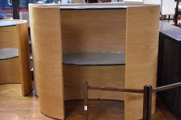 A modern Tom Schneider console table of elliptical form , with glass top and undershelf, natural