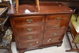 A reproduction mahogany media cabinet in the form of a chest of drawers, the two doors formed as