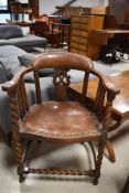 An early 20th Century oak captains style elbow chair