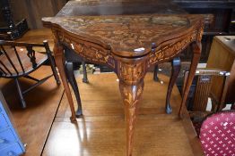 A 19th Century Dutch style marquetry fold over card table, of triangular form, width approx. 92cm in