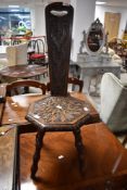 A traditional rustic carved spinning chair