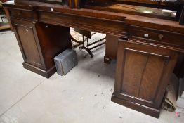 A 19th Century mahogany sideboard having ledge back frieze drawers on cupboard sections, width