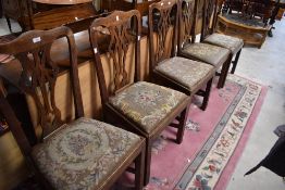 A group of five Georgian oak splat back dining chairs, each with yoke-form top rails and pierced