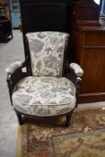 A Victorian mahogany tub chair having later floral upholstery