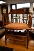 A late 19th or early 20th Century oak captains chair having turned supports and frame