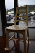A traditional painted ladder back kitchen chair