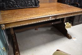 A 19th Century oak library style table having figural/mythical carving throughout, approx. 152 x