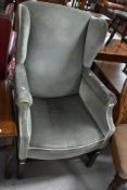 A traditional wingback armchair, probably early 20th Century