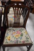 A Georgian mahogany dining chair, with shaped top rail and tapering pierced splat, the needlework