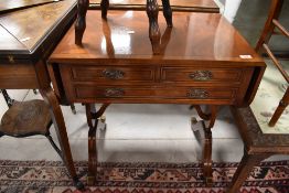 A reproduction Regency style work table having drop flap and two short over one long frieze drawers,