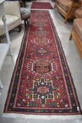 A traditional Persian style carpet runner, approx. 380 x 73cm
