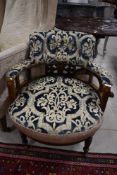 An Edwardian mahogany tub chair having later button back upholstery and inlaid decoration , on
