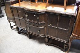 An early 20th Century oak breakfront sideboard, width approx. 152cm