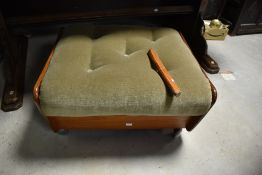 A vintage teak stool, having green dralon buttoned seat and castors to base, please note this is