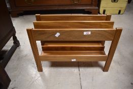 A vintage two-division magazine rack, thought to be teak or similar 36cm x 51cm