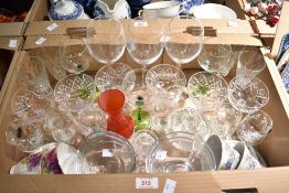 A collection of assorted drinking glasses including three large wine glasses and six cut glass