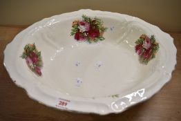 A large oval water bowl having ebossed pattern and floral design.