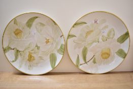 A pair of large decorative plates having hand painted design and gilt decoration to rim, with script
